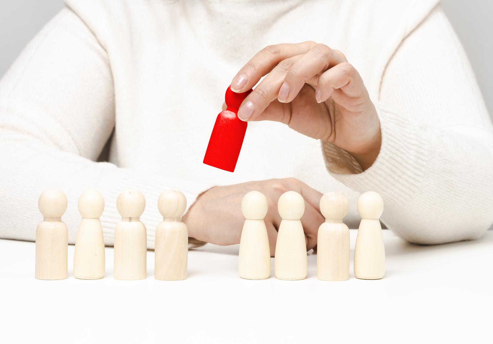 Figurines on a white table. concept of searching for employees in the company, recruiting personnel, identifying talented and strong personalities