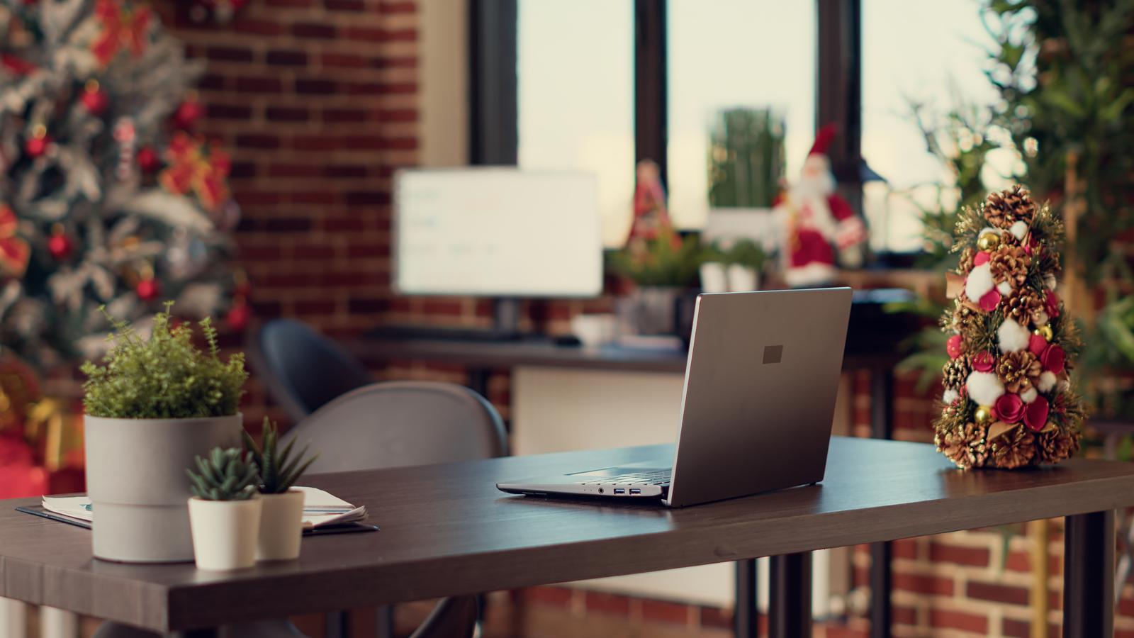 Startup office with laptop and christmas decorations How to Retain Top Talent Through the Holidays and Into the New Year