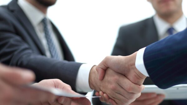 handshake business colleagues in office