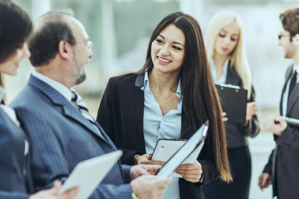 businessman and members of the business team discussing business documents standing in the lobby of the modern office.