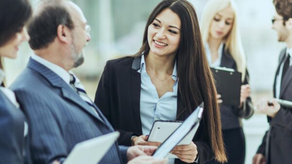 businessman and members of the business team discussing business documents standing in the lobby of the modern office.