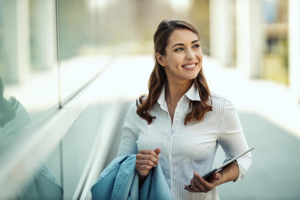 Young smiling businesswoman with tablet in her hands is going to work. employee onboarding